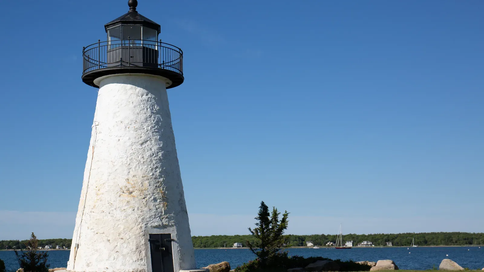 Ned Point Light, a white stone lighthouse with a black lantern room overlooking Mattapoisett Harbor, Mattapoisett, Massachusetts